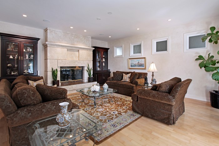 Living room with fireplace, sofas, and armchairs