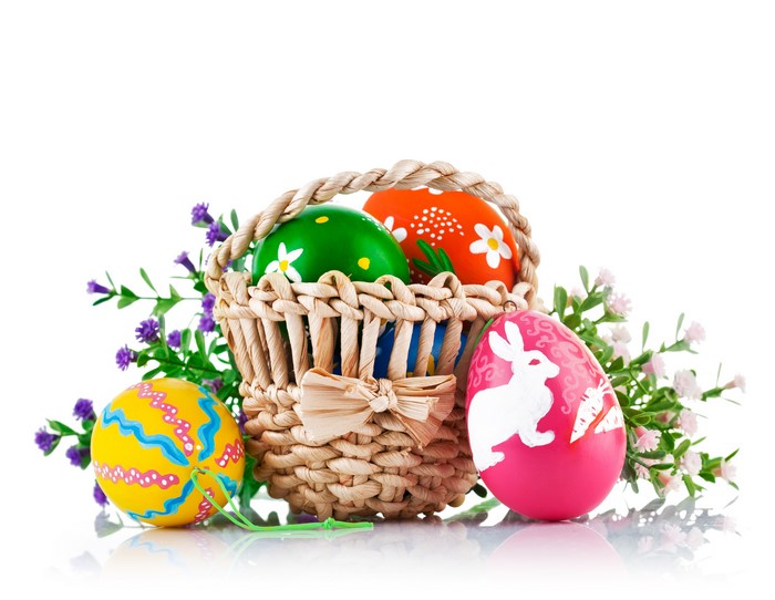 Easter eggs in a wicker basket with flowers