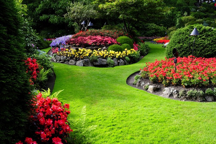 A beautifully landscaped garden with colorful flowers and green lawns