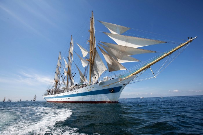 Tall ship sailing on the sea with other ships