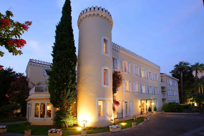 Castle hotel in Cannes, France at dusk