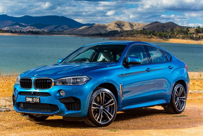 Blue 2015 BMW X6 M (F16) parked by a lake