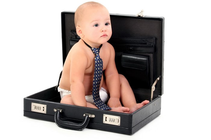 Baby in a briefcase wearing a tie