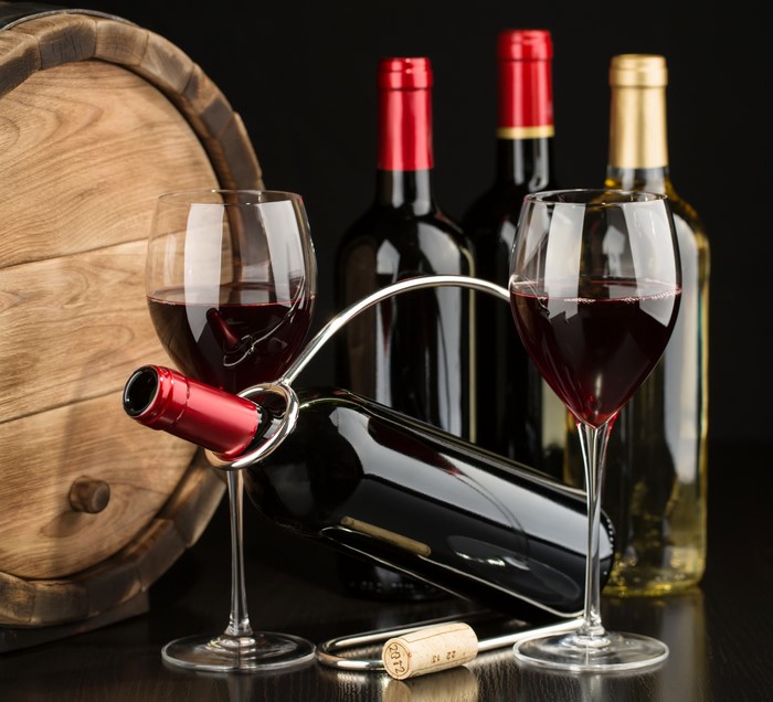 Wine bottles, glasses, barrel, and cork