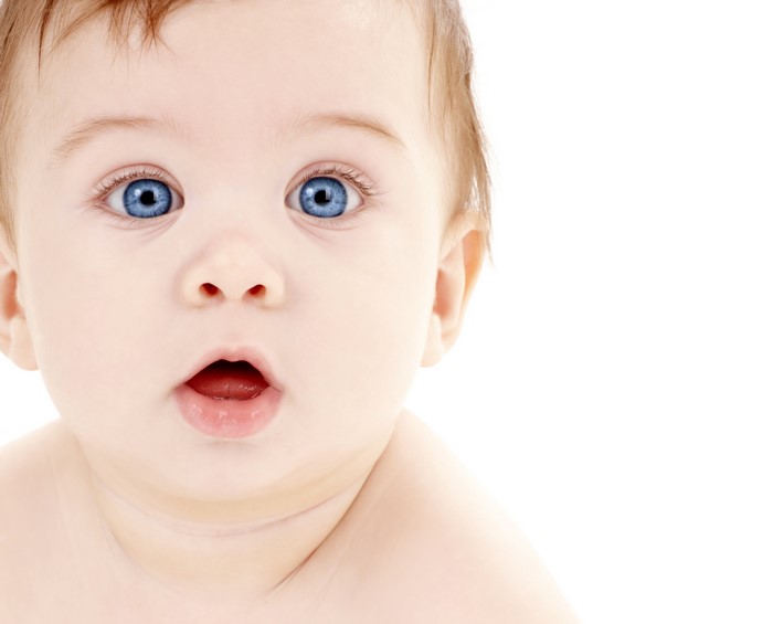 Close-up of a baby's face with blue eyes