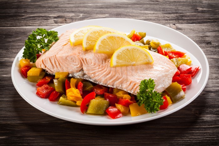 Salmon fillet with lemon and vegetables on a plate