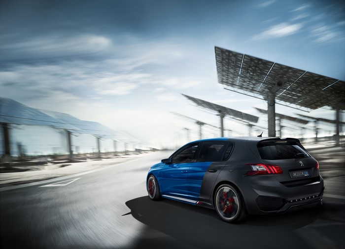 Peugeot 308 R HYbrid driving past solar panels