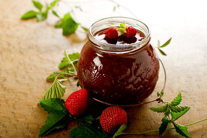 Strawberry Jam in a Jar with Strawberries and Foliage