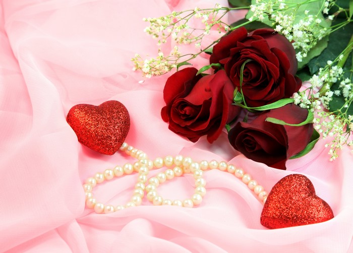 Red roses, pearls, and hearts on pink fabric