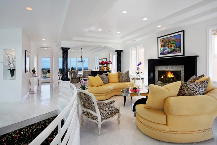 Luxurious living room with fireplace and yellow sofa