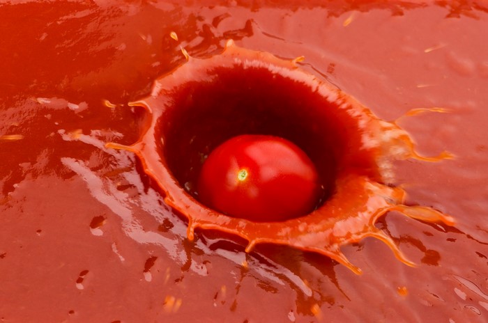 Tomato splashing into tomato juice