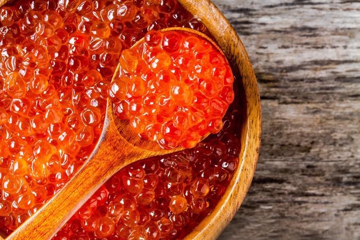 Red Caviar in a Wooden Bowl with a Spoon