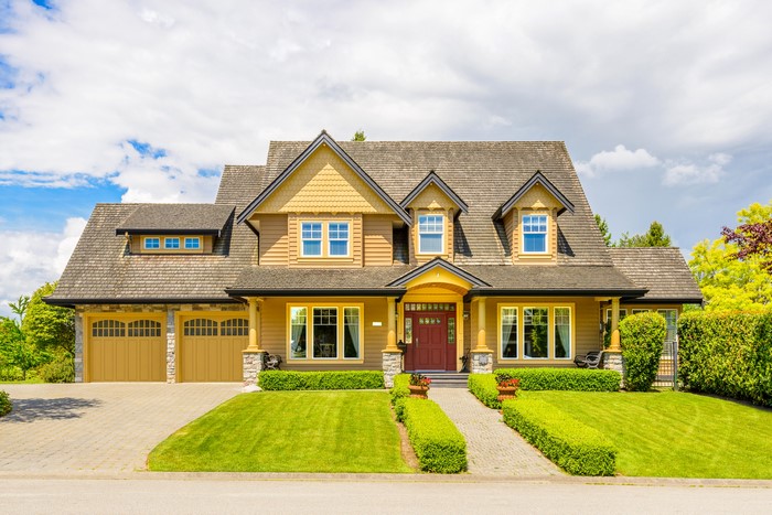 Luxury house with manicured lawn and garage