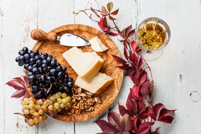 Grapes, Cheese, Nuts, and Wine with Autumn Foliage