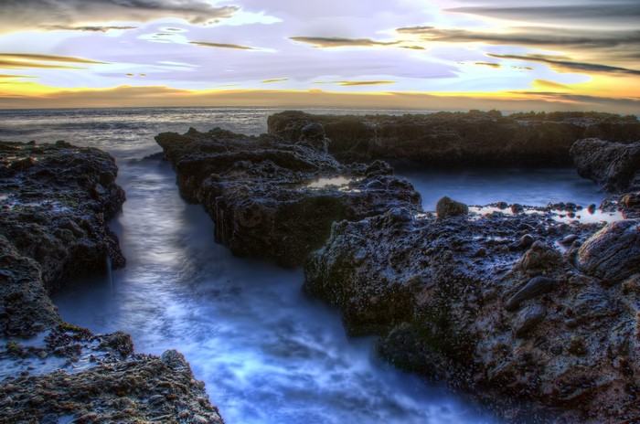 Sunset over rocky coast in California, USA