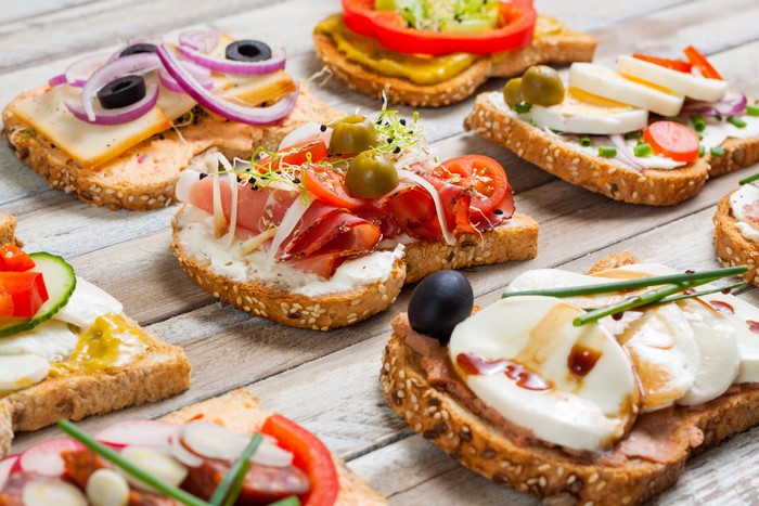 Assortment of open-faced sandwiches with various toppings