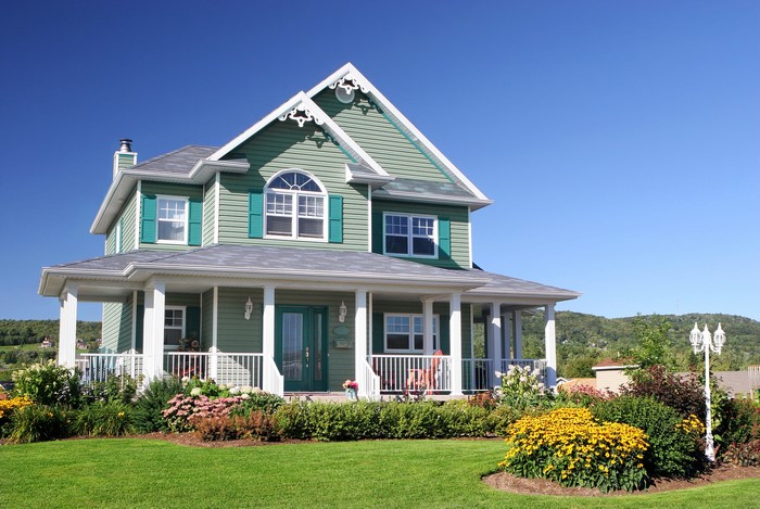 Green house with porch and garden
