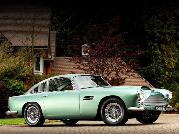 Aston Martin DB4 parked in front of a house