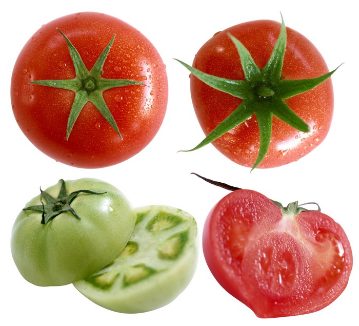 Four tomatoes, two red, one green, one sliced red