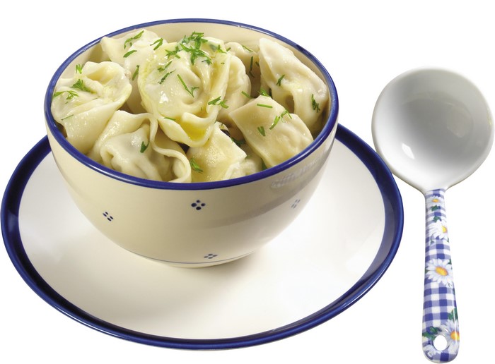 Pelmeni in a bowl with a spoon