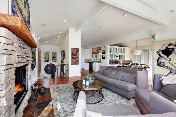 Living room with fireplace, sofa, and table