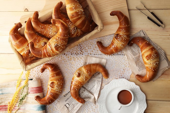 Croissants with sesame seeds on a wooden table