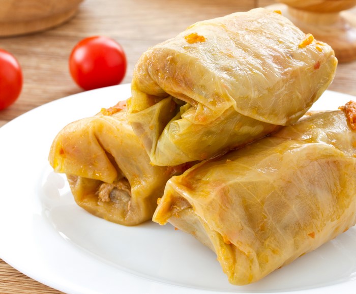 Three cabbage rolls on a white plate