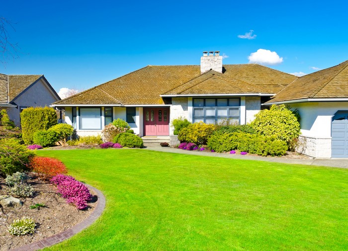 Single-family house with manicured lawn and landscaping