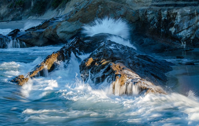 Waves crashing on rocky shore in California