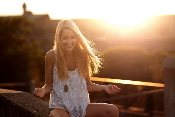 Blonde girl smiling at sunset