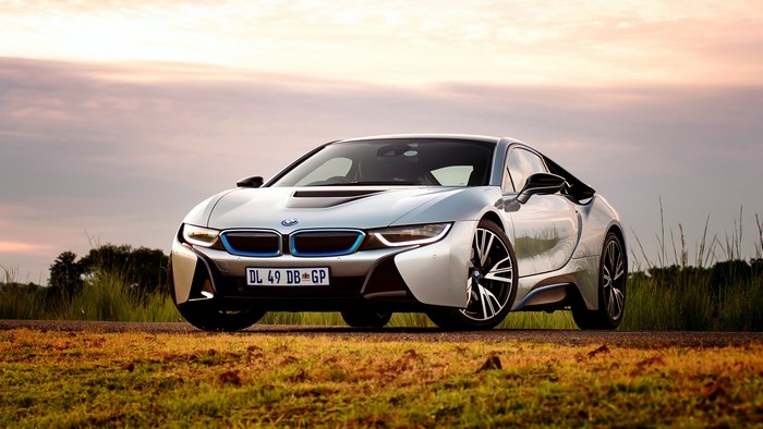 BMW i8 car on a road at sunset