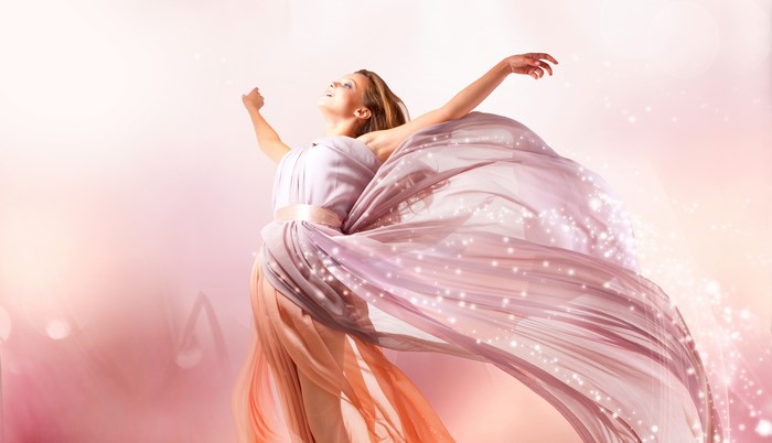 Woman in a flowing pink dress with sparkles
