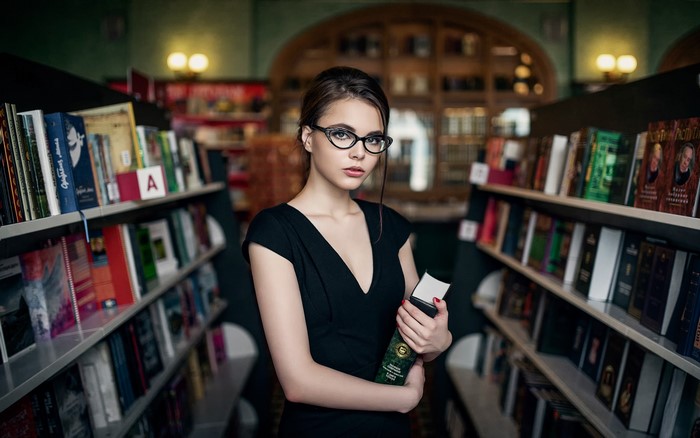 Oktiabrina Maximova in a library holding a book