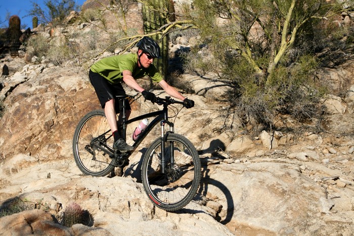 Man riding a bicycle on a rocky trail