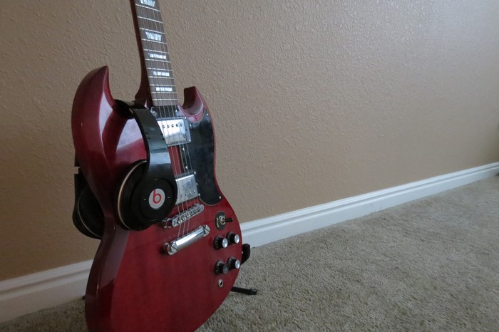 Red electric guitar with Beats headphones