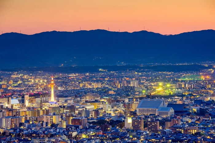 Kyoto cityscape at dusk with mountains