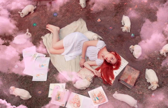 Redhead girl with rabbits and books