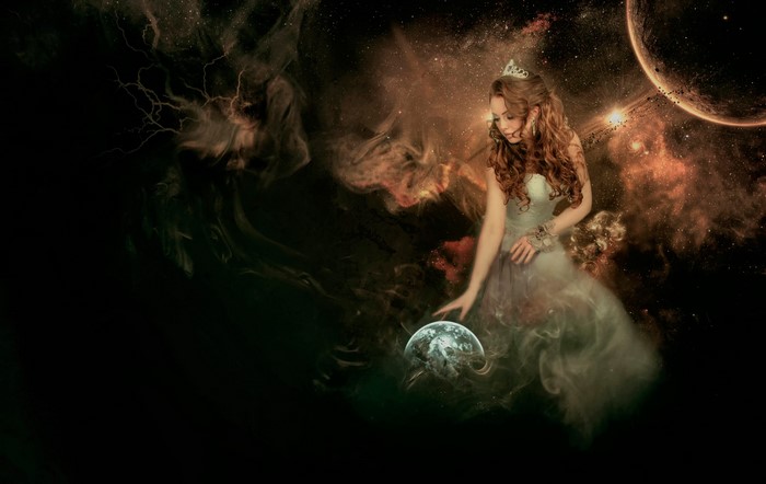 Woman in a dress holding Earth in space