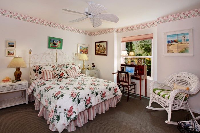 Bedroom with floral bedding and desk
