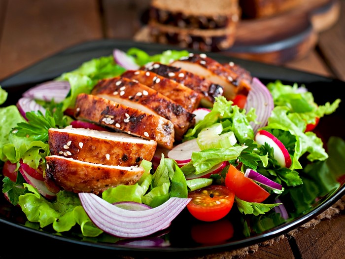 Sliced grilled chicken salad with vegetables