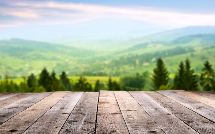 Wooden planks in front of a blurred mountain landscape