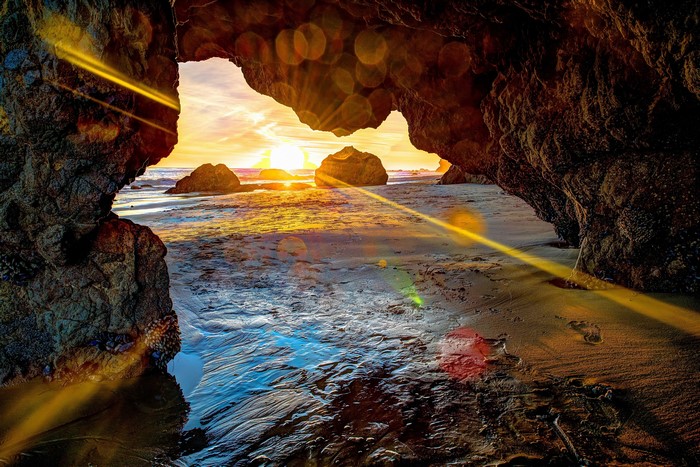 4K Sunset Through Coastal Rock Arch