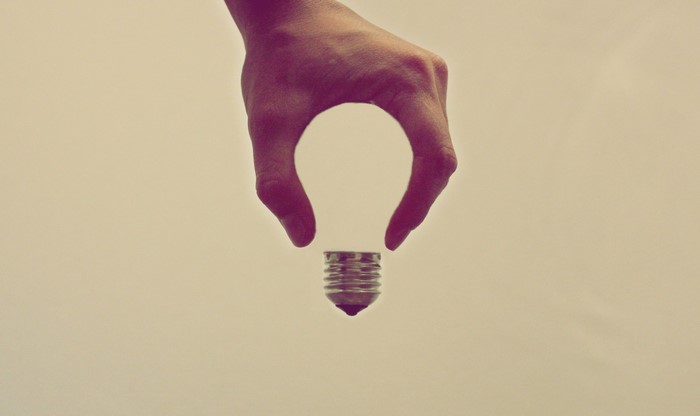 Hand holding a light bulb base