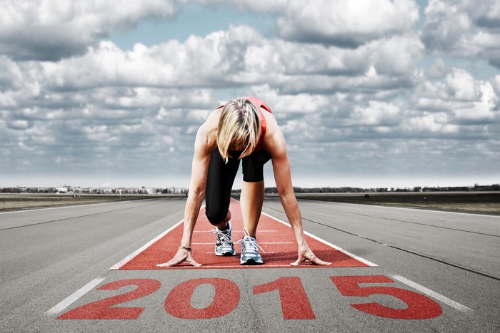 Woman at starting line with 2015 painted on track