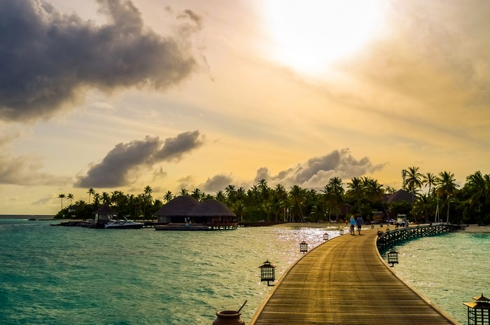 Maldives tropical island resort with overwater bungalows and pier