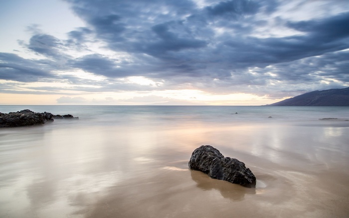 Long exposure of a rocky beach at sunset