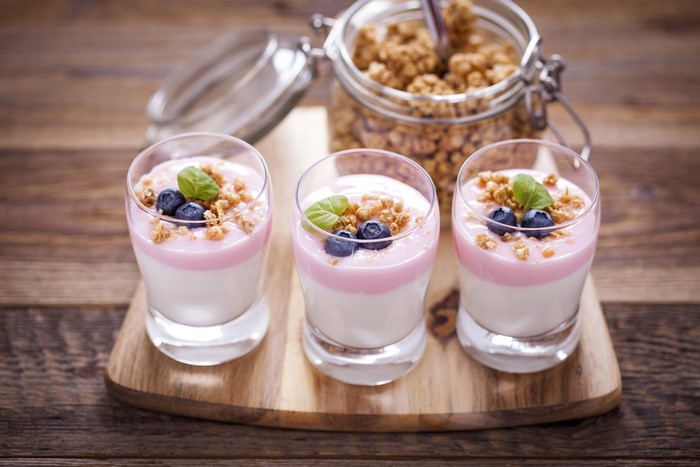 Three glasses of yogurt with blueberries and granola