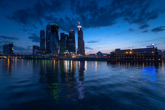 Moscow skyline with skyscrapers and river at night