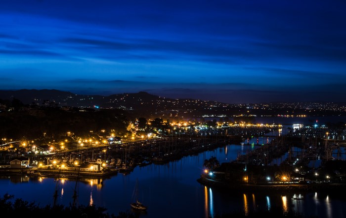 Marina at night with city lights in California