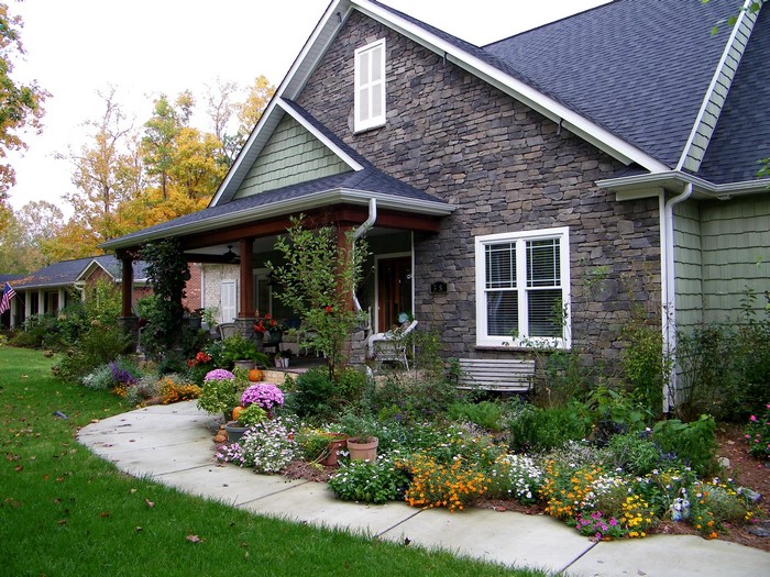 House with stone facade and colorful garden